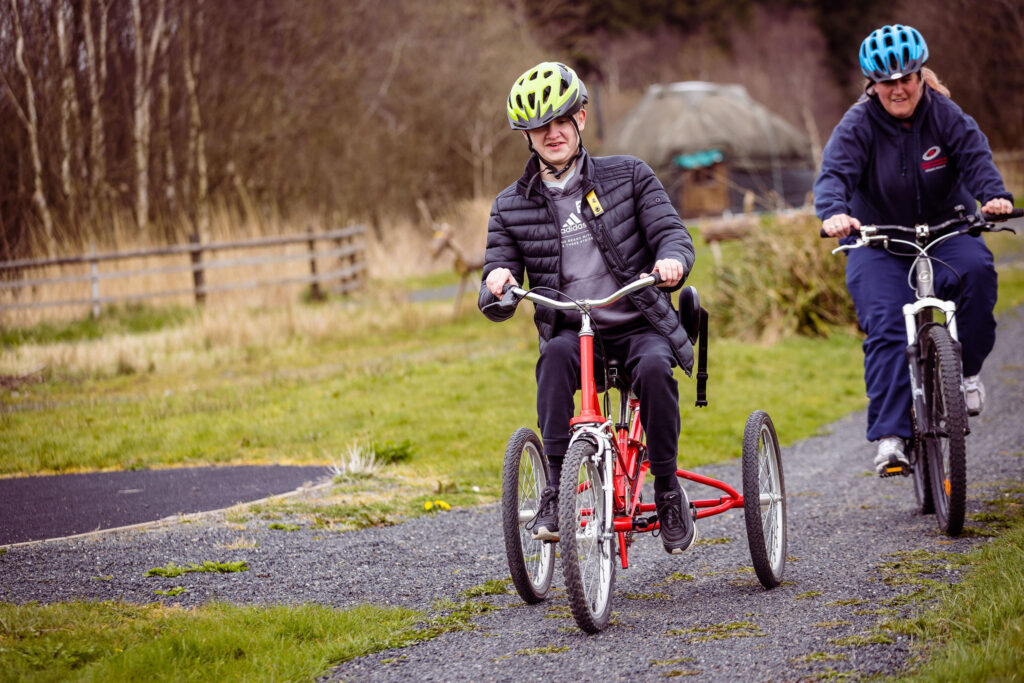 Visitor of Bendrigg riding a tricycle